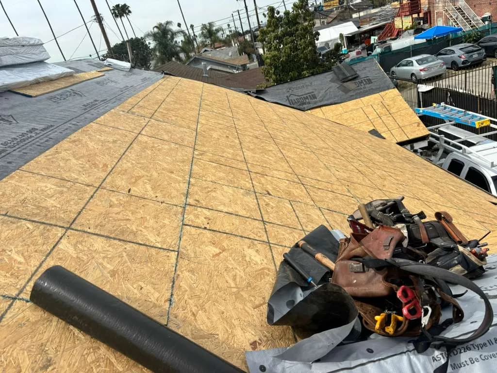 Wood roof decking with underlayment along the neighboring roof slope