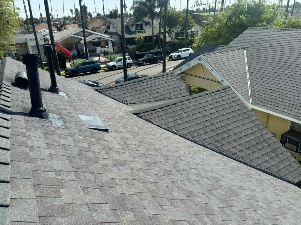 Shingle roof slopes and an edge with nearby roof penetrations