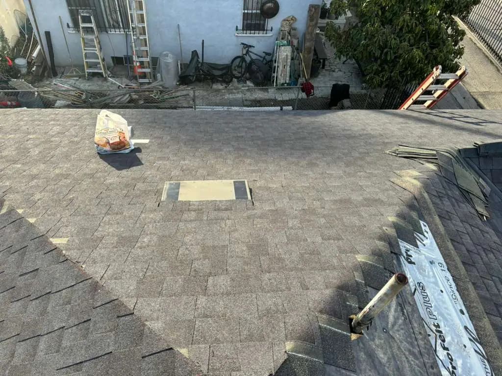 Shingle roof planes with a valley and a small roof penetration