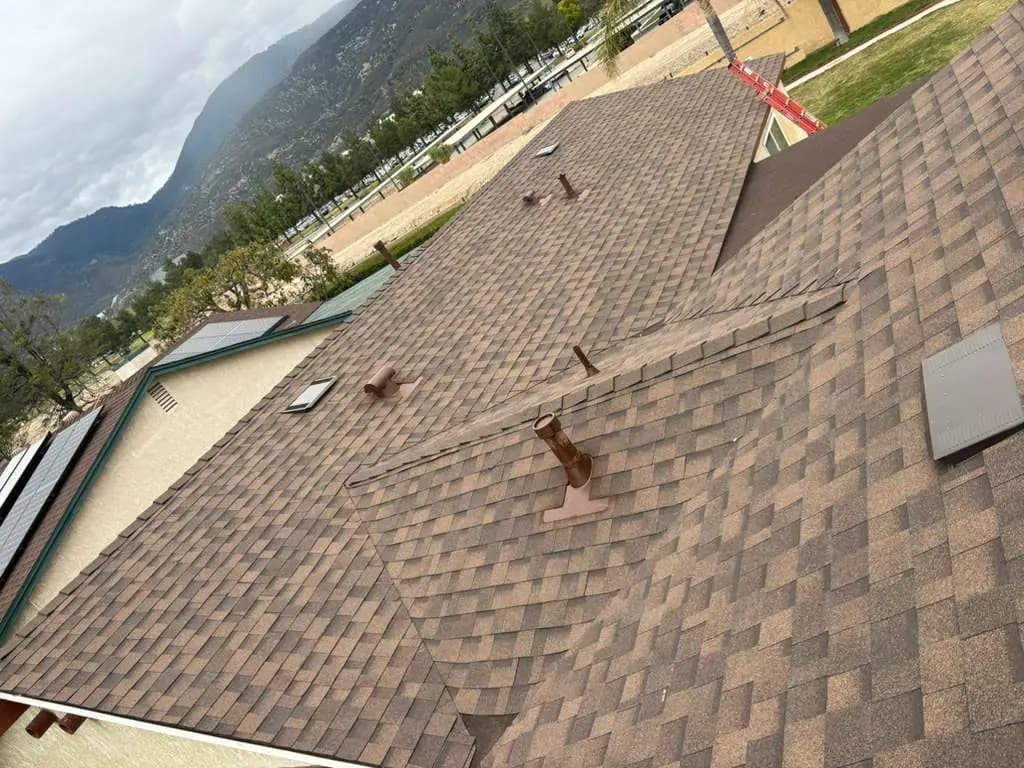 Dimensional shingles with vents and a ridge across the roof