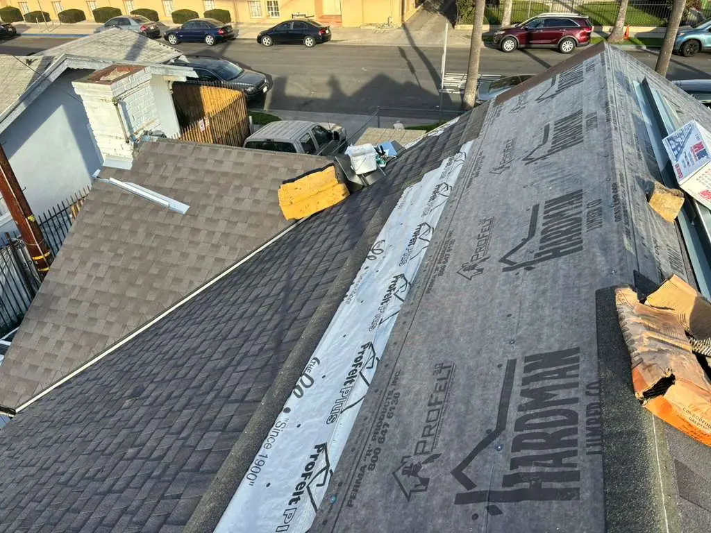 Shingle covering beside printed underlayment on an adjoining roof slope