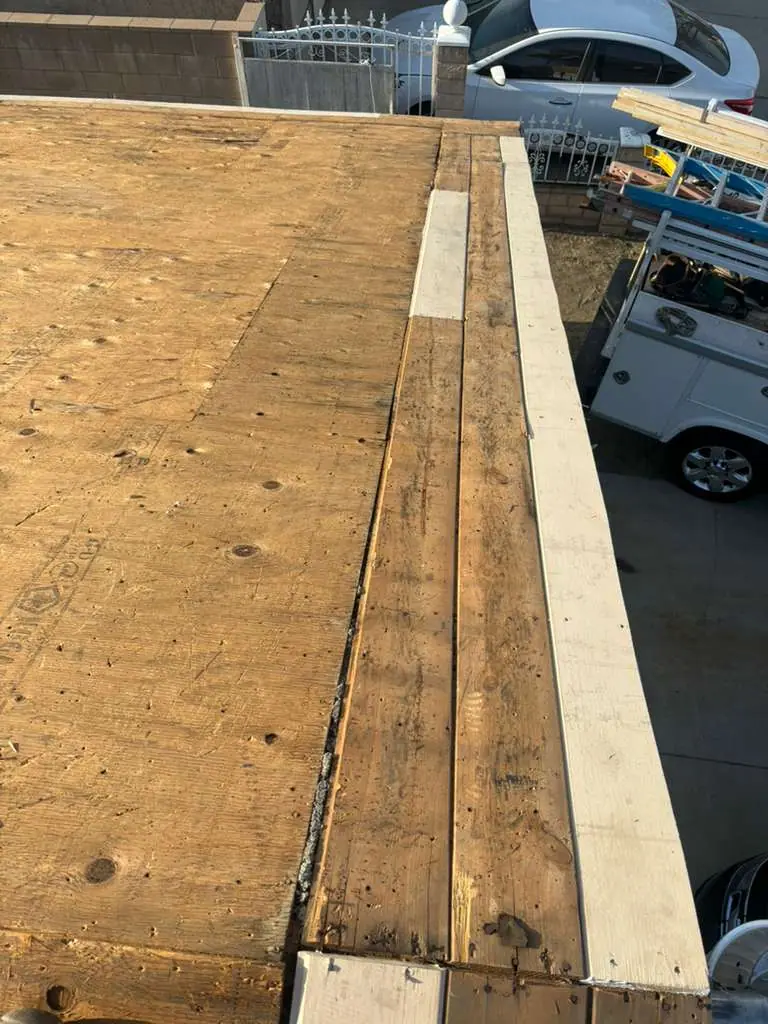 Wood roof decking and edge boards viewed from above