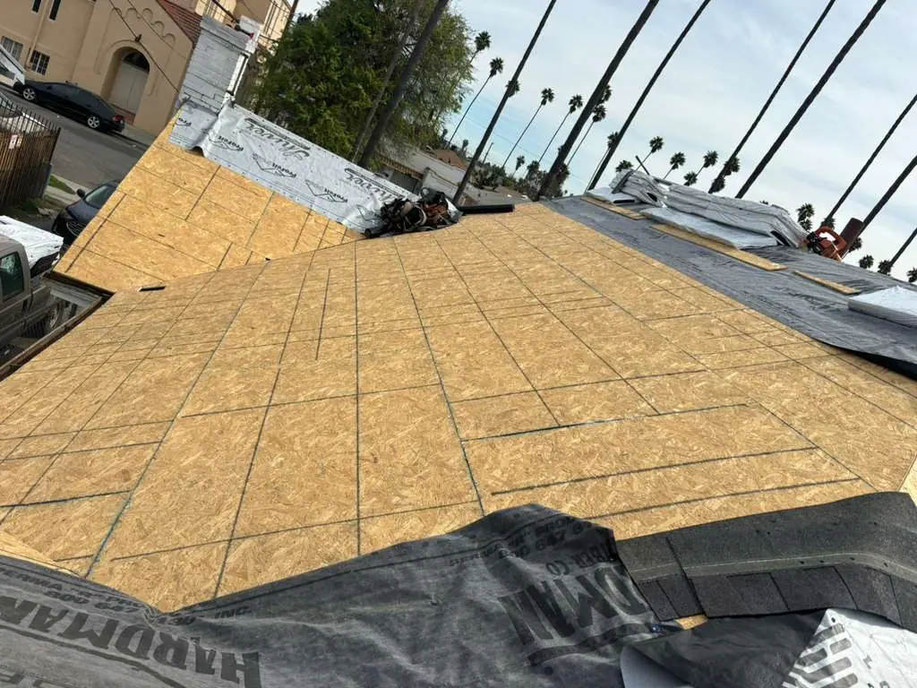 Exposed wood roof deck with marked lines across the surface