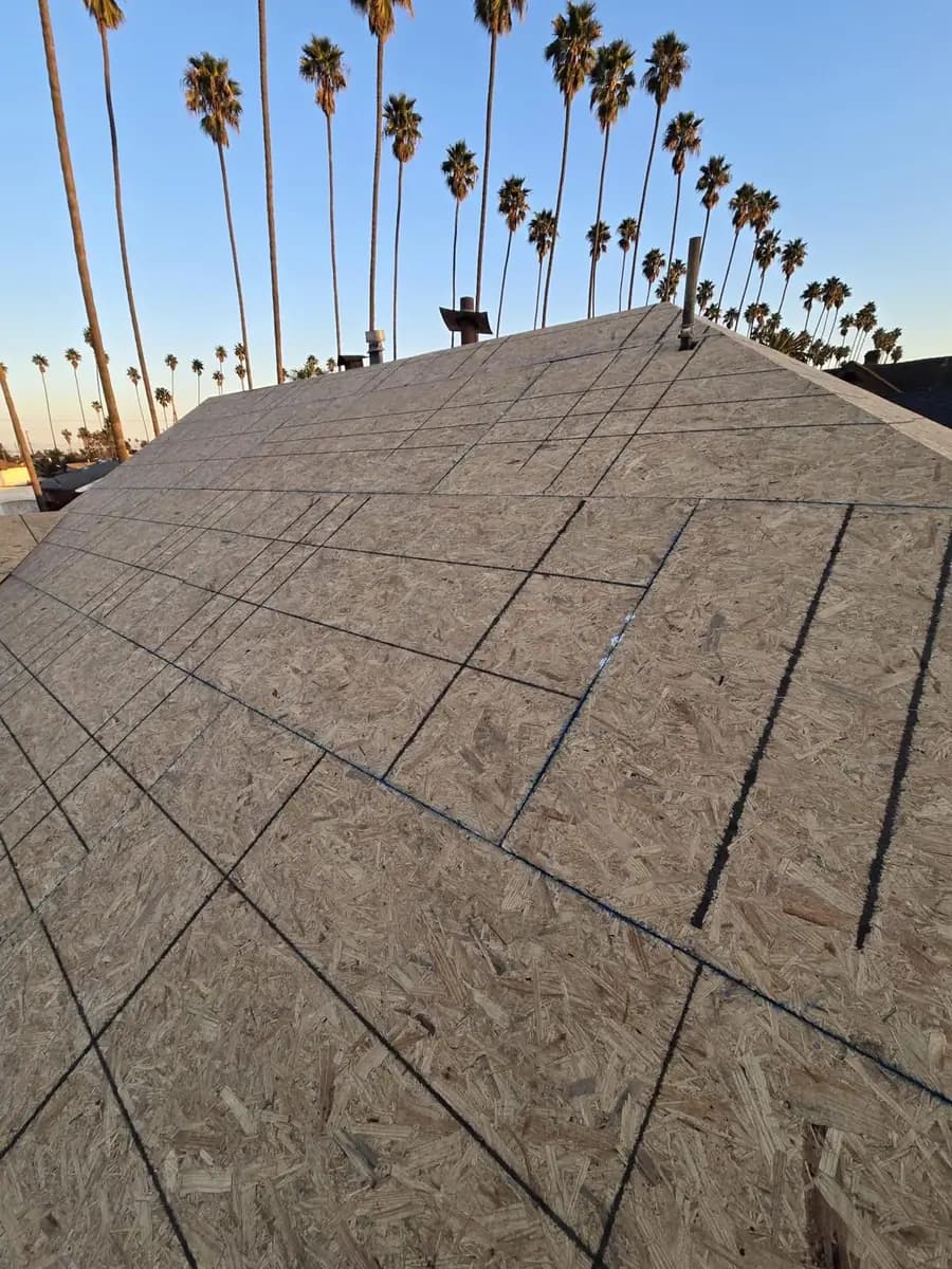Marked wood decking on a pitched roof with vent penetrations