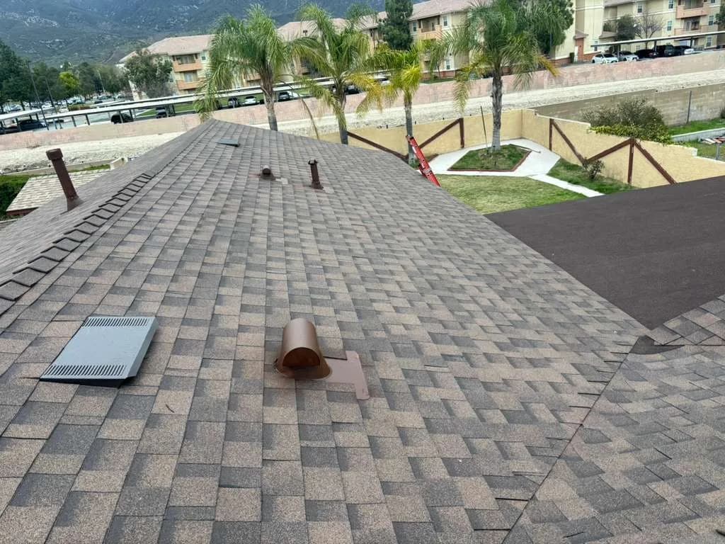Dimensional shingle roof with vent penetrations and hip and ridge details